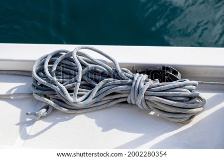 Mooring ropes on the sailing boat deck background. Gray color yachting rope on the ship bow, Closeup view, Sailboat cruise in Aegean sea, Greece