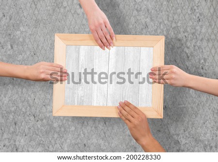 Close up of human hands holding wooden frame