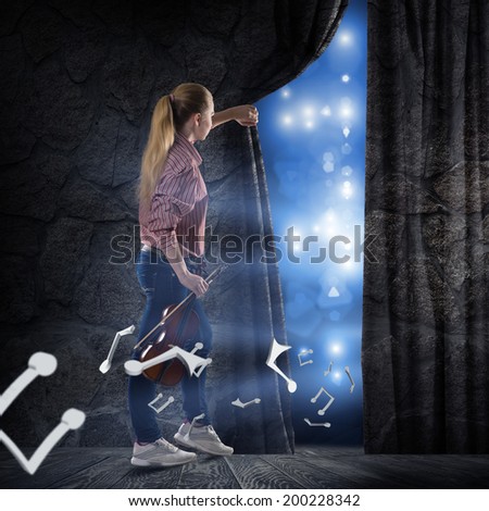 image of a young woman pushes the curtain behind which concert lights