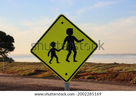 mother and child crossing sign