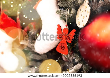 Different Christmas toys at the christmas tree. Fir tree toys close up. Holiday decoration toys. Merry Christmas greeting card.