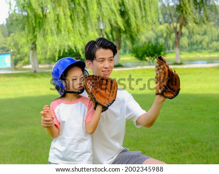Happy father and daughter are playing baseball in the park high quality photo
