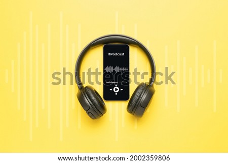 Podcast icon. Audio equipment with microphone, sound headphones, podcast application on mobile smartphone screen. Radio recording sound voice on yellow background. Broadcast media music concept Royalty-Free Stock Photo #2002359806