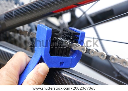 Hand of a mechanic cleaning a bicycle chain isolated