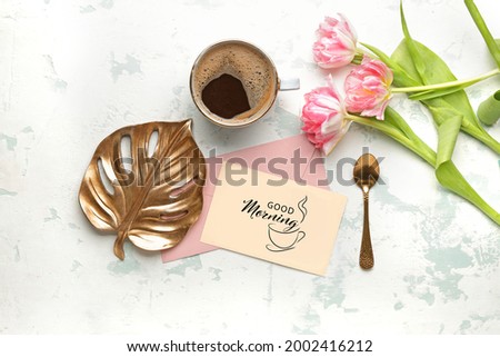 Composition with coffee, flowers and greeting card with text GOOD MORNING on white background