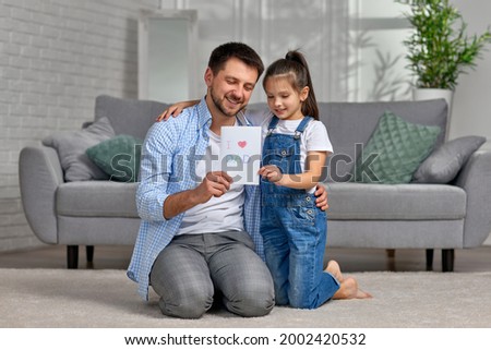 Father's day. daughter giving dad a greeting card