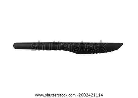 Plastic table knife on white background isolated closeup, disposable plastic tableware, one-off black plastic knife, cutting food knife, kitchen utensil, cutlery for breakfast, lunch, dinner, supper