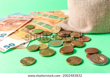 Euro bills and small change cents on a green background. Concept. High quality photo