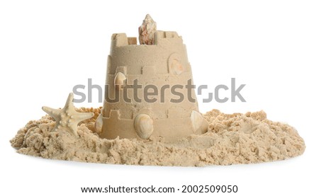 Sand castle with shells and starfish on white background. Outdoor play