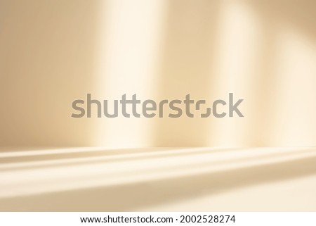 Abstract pastel yellow studio background for product presentation. Empty room with shadows of window. Display product with blurred backdrop. Royalty-Free Stock Photo #2002528274