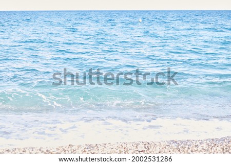 Beautiful Mediterranean sea and waves backgrounon sunny day. Summer and restconcept. Summer texture. Bright wallpaper. Turquoise seawater. Royalty-Free Stock Photo #2002531286