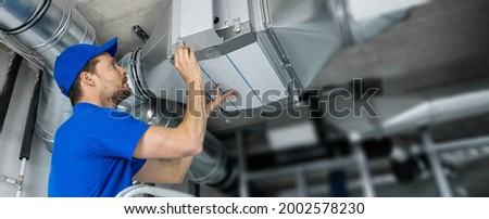 ventilation system installation and repair service. hvac technician at work. banner copy space Royalty-Free Stock Photo #2002578230