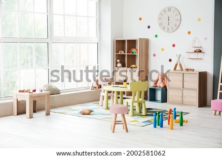 Stylish interior of modern playroom in kindergarten Royalty-Free Stock Photo #2002581062