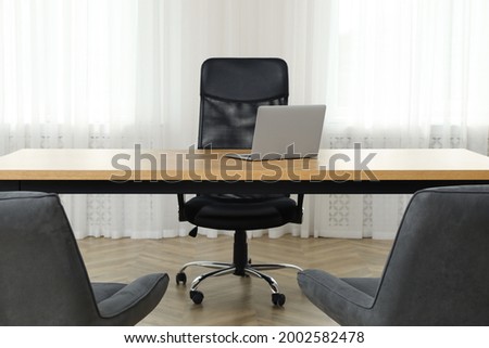 Director's office with large wooden table and comfortable armchairs. Interior design Royalty-Free Stock Photo #2002582478