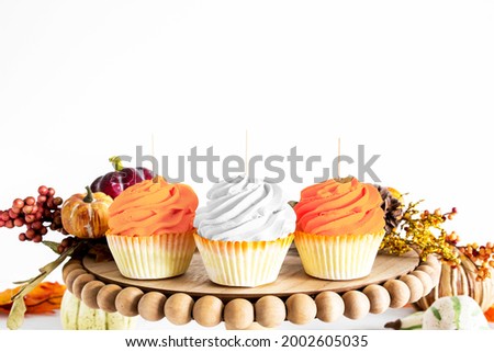 2 orange and 1 white cupcake on pie tray with fall decor, thanksgiving topper mockup