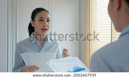 Young female leader, asia people lady or mba student happy standing smile look at in front of mirror pep talk for sale pitch hold paper document script public speak skill for job career self improve. Royalty-Free Stock Photo #2002607939