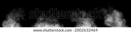 Set. Close-up of steam or abstract white smoke floating on top. Visible water droplets swirl beautifully. isolated on a black background Royalty-Free Stock Photo #2002632464