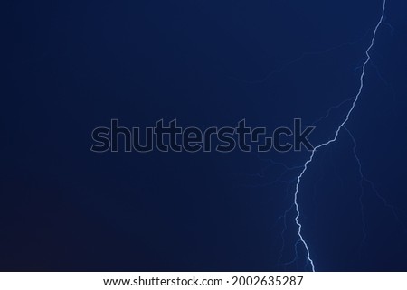 Thunderstorm. Lightning in the night blue sky