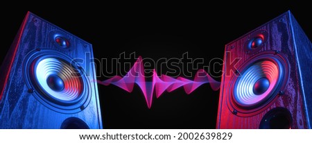 Two sound speakers in neon light with sound wave between them on black. Royalty-Free Stock Photo #2002639829