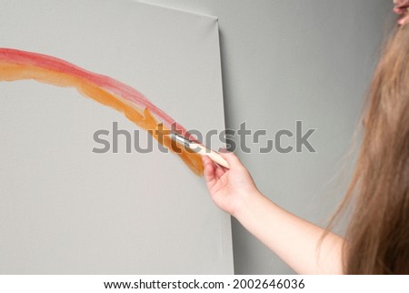 kid drawing red line art with paints