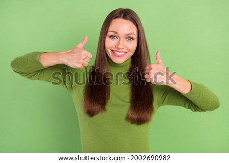 Photo of positive nice pretty young woman make thumbs up recommend isolated on green color background