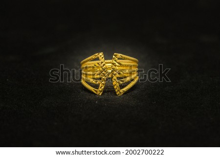 real gold ring on black background