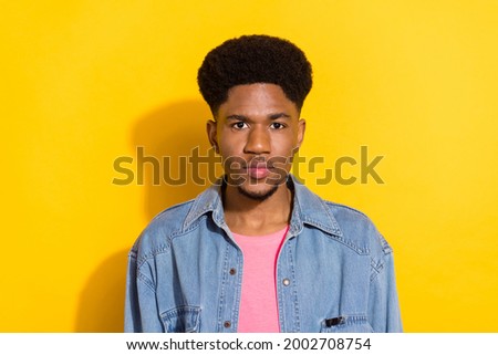 Photo of serious afro american young man wear denim shirt casual isolated on yellow color background