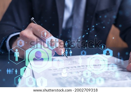 A potential employee in formal suit signing the contract to boost his career and gain new opportunities in personal growth. Concept of success. Hiring a new talented crew. Social media hologram icons