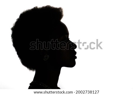 Close up profile silhouette portrait of african american black woman on white studio background. Royalty-Free Stock Photo #2002738127