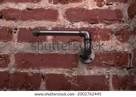 metal holder for toilet paper and paper towel roll in loft style on brick wall

