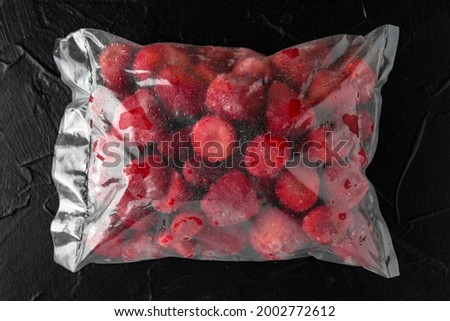 Disposable strawberries ready to be sold, eaten, or frozen. Semi-finished product for long-term storage Royalty-Free Stock Photo #2002772612