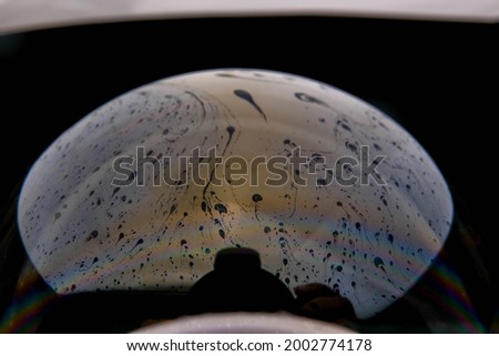 closeup photo of colored light reflection on the surface of soap bubble