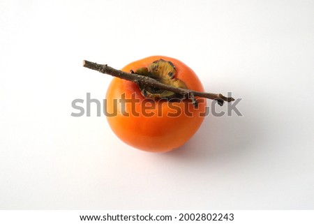 The photo of a persimmon on the white background.