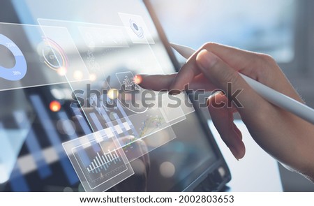 Data scientists, Business woman touching on digital tablet computer analyzing business report, financial graph on futuristic virtual interface screen. Algorithm,  marketing and business intelligence Royalty-Free Stock Photo #2002803653