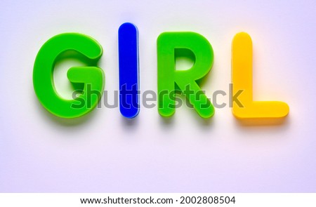 Plastic letters spelling GIRL on white