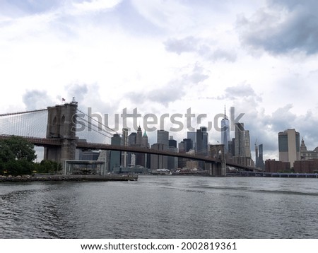 A beautiful panoramic view of iconic Brooklyn Bridge and Manhattan Skyline on a overcast day in New York City,USA