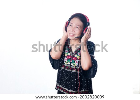 Portrait of a middle-aged Asian woman with headphones isolated on white background.