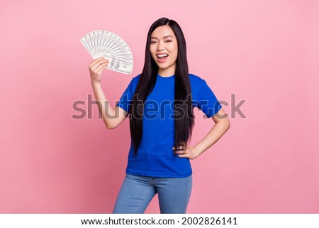 Photo of cheerful young positive woman hold hands money profit waist isolated on pastel pink color background