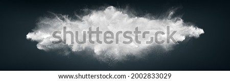 Abstract wide horizontal design of white powder snow cloud explosion on dark background Royalty-Free Stock Photo #2002833029