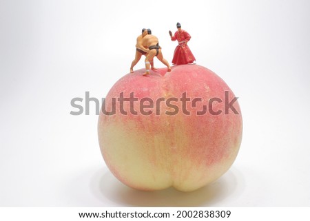 a figure of Sumo wrestler on the peach

