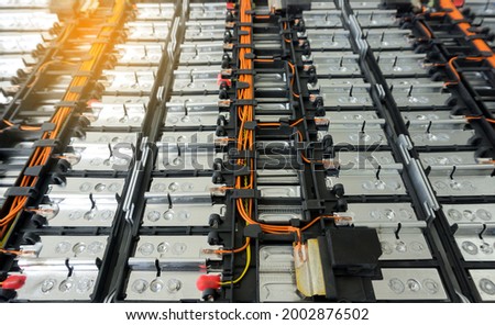 Selective focus of Electric car lithium battery pack and wiring connections internal between cells on background. Royalty-Free Stock Photo #2002876502