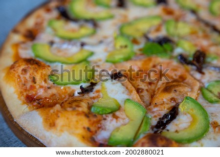 Close Up on a vegetarian pizza. Green margarita. Soft focus candid photo