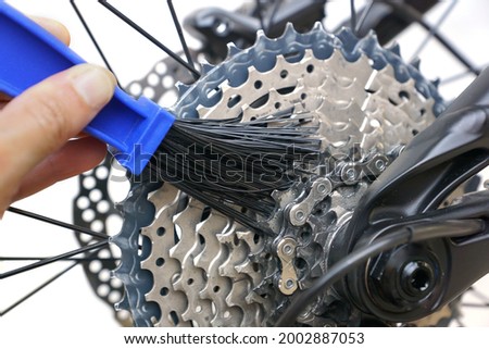 Hand of a mechanic cleaning a bicycle chain isolated
