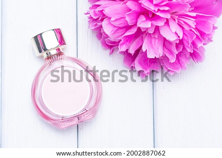peonies and bottle of perfume