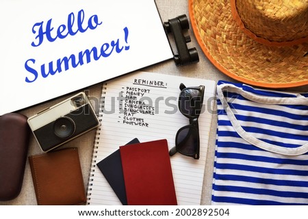 Hello Summer text with accessories and checklist of a traveler. Retro style photo. Top view. 