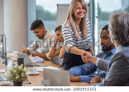 Business people shaking hands. Successful partnership. Business people shaking hands, finishing up a meeting. Cropped shot of two businesspeople shaking hands during a meeting in the boardroom Royalty-Free Stock Photo #2002915553
