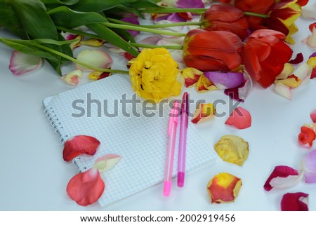 Many multi-colored rose and tulip petals