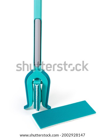 Flat wet mop with working part folded in half via the special clamp sliding on handle to squeezing out excess moisture and additional replaceable working head on a white background
