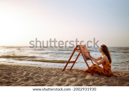 Creative female artist drawing the picture at the beach. Art, creativity and inspiration concept. Canvas Painting.
