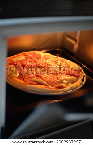Pizza is an Italian dish consisting of a usually round, flattened base of leavened wheat-based dough topped with tomatoes, cheese, and often various other ingredients, which is then baked at a high te